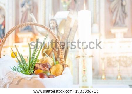 Easter food basket for blessing in church, catholic eastern european custom with eggs, spring onion, ham and bread, artistic edit Royalty-Free Stock Photo #1933386713