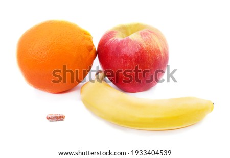 Vitamin pill with fruit isolated on a white background.