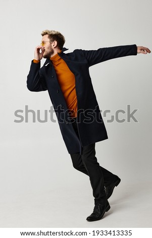 man black coat movement dance fashion modern style isolated background. High quality photo