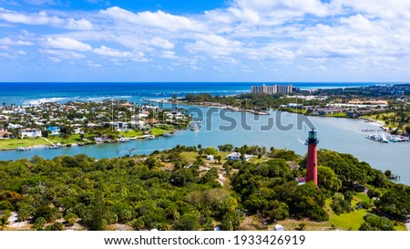 Jupiter is a town on the southeastern coast of Florida. On a hill overlooking the Loxahatchee River, the red 1860 Jupiter Inlet Lighthouse offers panoramic views. The site also has a preserved pioneer Royalty-Free Stock Photo #1933426919