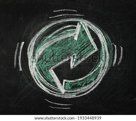 Recycling symbol drawn chalk on black chalkboard, blackboard background and texture 