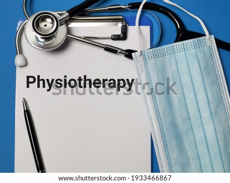 Phrase PHYSIOTHERAPY written on paper clipboard with stethoscope and medical face mask. Medical and health concept.