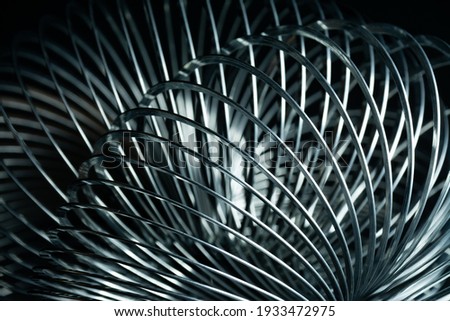 Abstract metal spirals with black background.