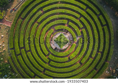 Aerial view of a circular garden maze and green pavilion Royalty-Free Stock Photo #1933507403