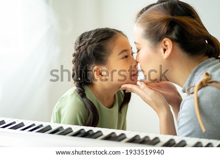 Happy loving family, Mom and daughter playing and kissing, Togetherness concept.