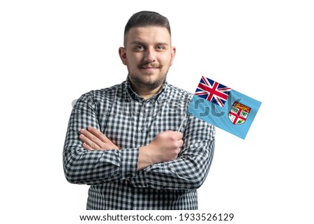 White guy holding a flag of Fiji smiling confident with crossed arms isolated on a white background.