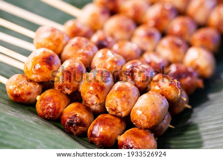 Close up of sausage grilled Thai traditional style, Sai krok isan, pork and rice, thai street food market Royalty-Free Stock Photo #1933526924