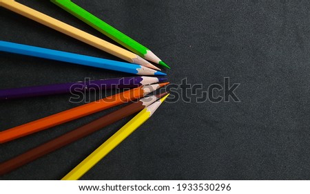 Arrangement Colored pencils make shaping on black background.for background and wallpaper