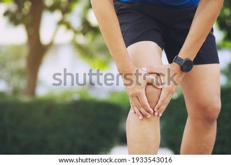 Close up athlete man, Knee pain after exercise .It happens often in athletes practice overtain.In arthritis concept. Royalty-Free Stock Photo #1933543016