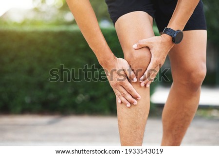 Close up athlete man, Knee pain after exercise .It happens often in athletes practice overtain.In arthritis concept. Royalty-Free Stock Photo #1933543019