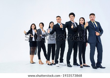 Full picture of professional staff with thumbs up and looking to the left of the picture.