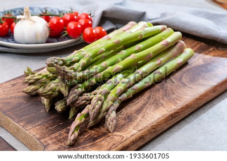 Bunch of fresh ripe green asparagus organic vegetables ready to cook or grill Royalty-Free Stock Photo #1933601705