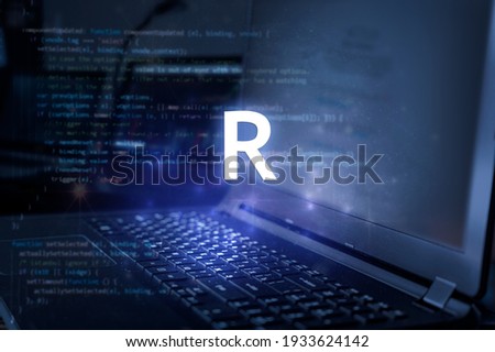 R programming language inscription against laptop and code background. Learn r, computer courses, training.  Royalty-Free Stock Photo #1933624142