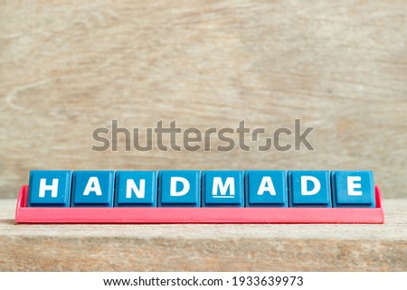 Tile alphabet letter with word handmade in red color rack on wood background