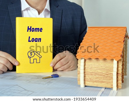 Financial concept meaning Home Loan with inscription on blank book 
