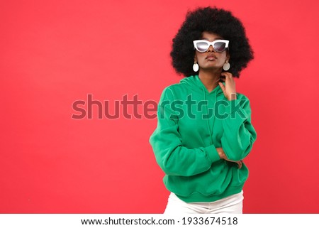 Fashionable fashion model on a red background.