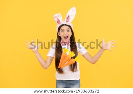 wow. happy easter. childhood happiness. child in rabbit ears and bow tie. time for fun. adorable kid looking funny with carrot. paschal spring holiday. happy teen girl wear bunny ears.