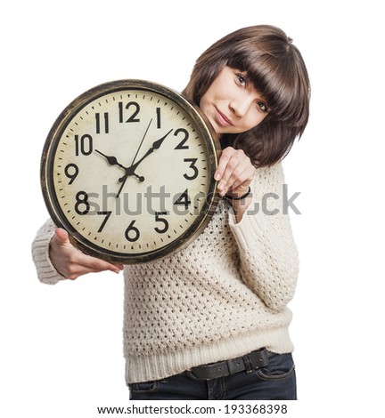 portrait of a pretty young woman showing a big clock