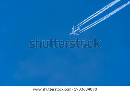 An airliner in flight on a day with clear blue sky. A picture with a clean background and space for text.