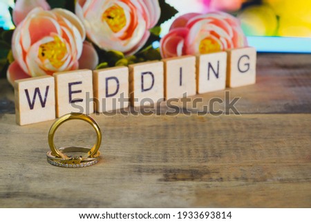 Wedding day tex with Duo Golden wedding ring on  background.