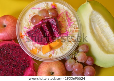 fruits photo with yellow background. fresh fruit salad with yogurt and cheese.