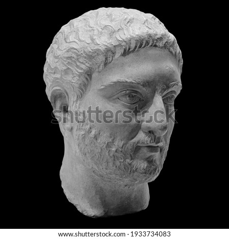 Head detail of the ancient man sculpture. Stone face isolated on black background. Antique marble statue of mythical hero character