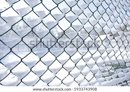 The lattice fence is covered with fresh snow.White background texture