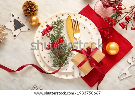 Beautiful Christmas table setting with mistletoe on white background Royalty-Free Stock Photo #1933750667