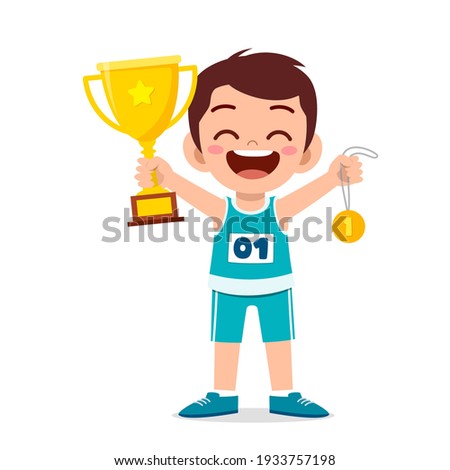happy cute little boy holding gold medal and trophy
