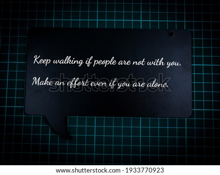 Motivational quote at wooden craft written a " Keep walking if people are not with you. Make an effort even if you are alone."