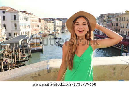 Portrait of a cheerful smiling tourist girl in straw hat in Venice, Italy Royalty-Free Stock Photo #1933779668