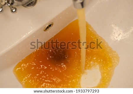 rusty water flows from the tap Royalty-Free Stock Photo #1933797293