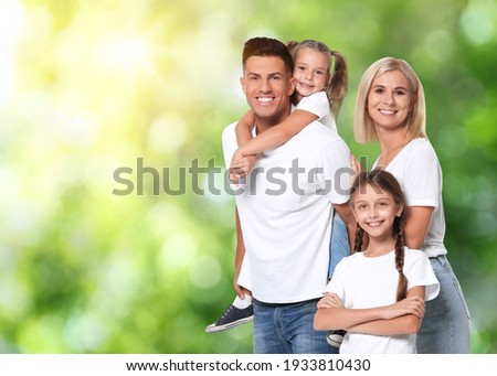 Happy family with children outdoors on sunny day, space for text