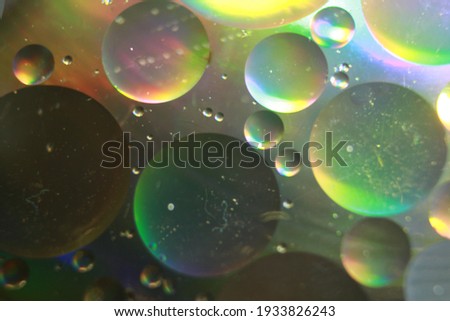 Color oil drop abstract background, Flat images with blurred and sharpen circles together with multicolor background. Stiring water and oil for dynamic holographic effect