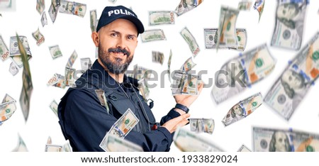 Young handsome man wearing police uniform inviting to enter smiling natural with open hand