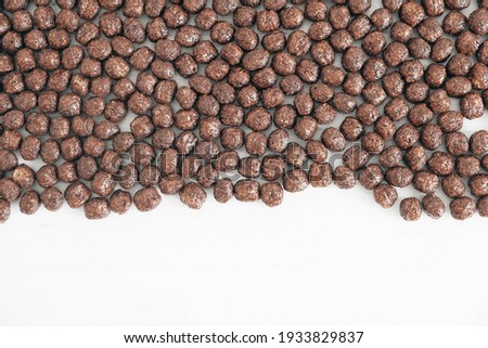 Chocolate corn balls scattered on a white background. Top view. Copy, empty space for text.