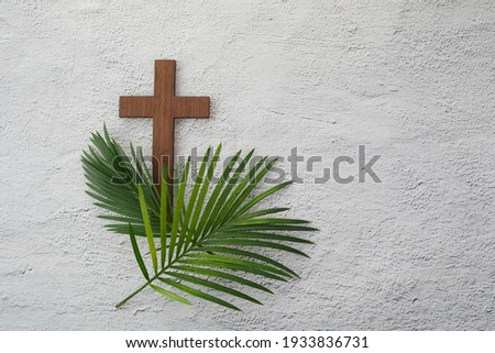 Palm sunday background. Cross and palm on grey background. Royalty-Free Stock Photo #1933836731