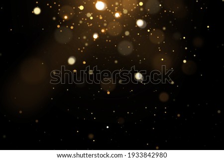 Festive abstract christmas texture, golden bokeh particles and highlights on dark background. High quality photo Royalty-Free Stock Photo #1933842980