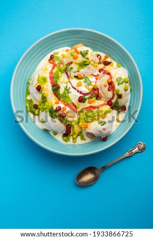 Dahi vada or bhalla is a type of chaat originating from the Indian and popular throughout South Asia. It is prepared by soaking vadas in thick dahi or curd. selective focus Royalty-Free Stock Photo #1933866725