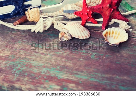 Marine items on wooden background. Sea objects on aged wooden planks. Selective focus.
