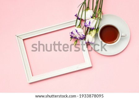  Flowers composition romantic. Spring flowers, photo frame on pastel background. Flat lay, top view, copy space