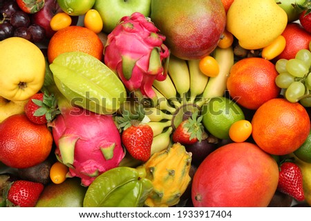 Assortment of fresh exotic fruits as background, top view Royalty-Free Stock Photo #1933917404