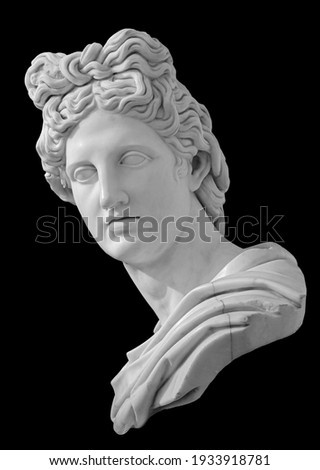 God Apollo bust sculpture. Ancient Greek god of Sun and Poetry Plaster copy of a marble statue isolated on black Royalty-Free Stock Photo #1933918781