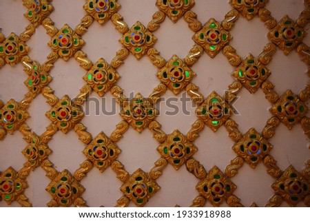 Close-up picture of the walls with stained glass, beautiful patterns, beautiful Thai cultural arts in Thai temples.