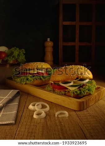 Burger on wooden tray. dark mood photography. 