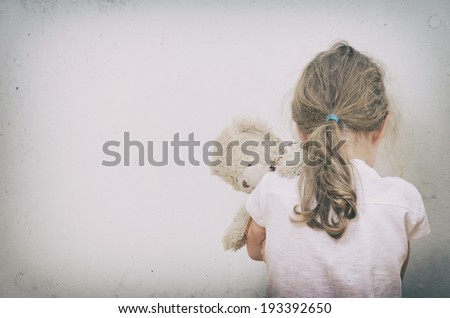 Little girl crying in the corner. Domestic violence concept. Royalty-Free Stock Photo #193392650