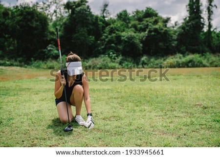 Portrait of golfer asian woman holding golf wood at the country club,Happy woman concept,Put golf on pin