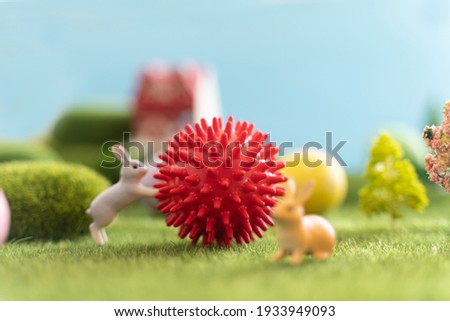 Ball coronavirus shape bunny toys and Easter eggs on green grass. Fairy tale. covid-19.