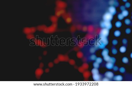 multicolored festive bokeh out of focus in the shape of a star, suitable for text in the foreground