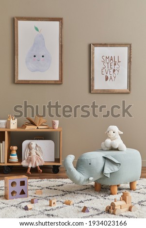 Stylish scandinavian kid room interior with toys, teddy bear, plush animal toys, furniture, decoration and child accessories. Brown wooden mock up poster frames on the wall. Template